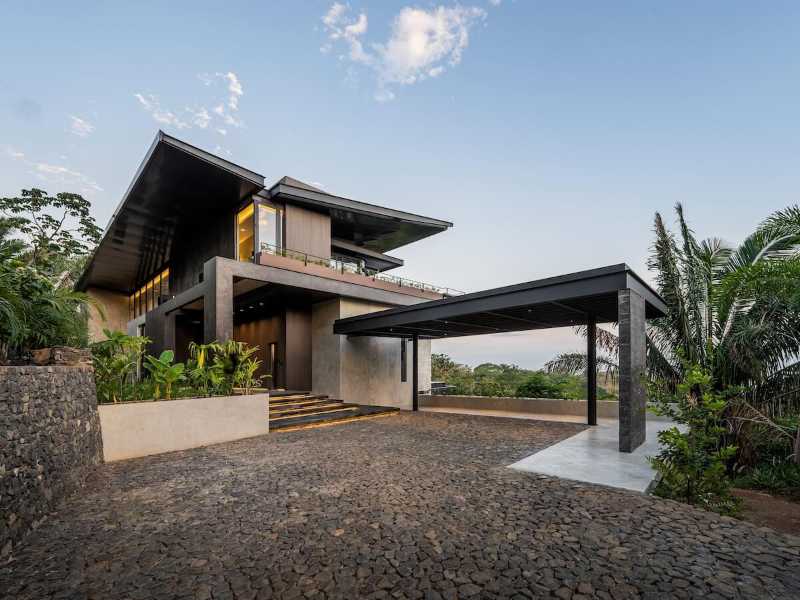 Contemporary tropical home exterior at Nosara Estates with modern architecture and lush jungle surroundings in Nosara