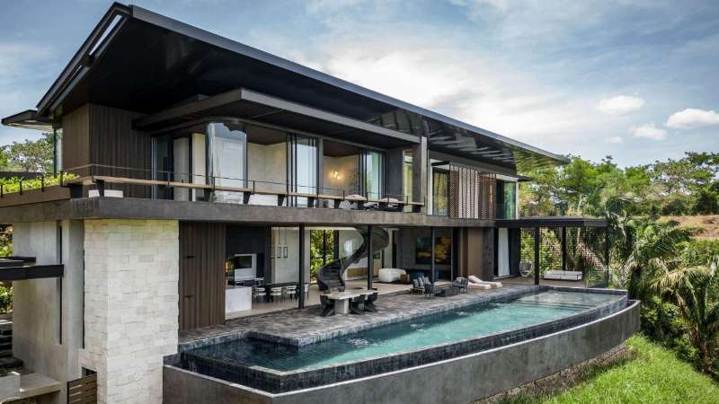 Completed modern home at Nosara Estates in Nosara showing finished exterior, landscaping, and driveway access